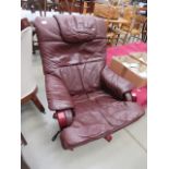 Burgundy leather effect swivel armchair