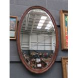 Oval bevelled 1920s mirror in oak frame