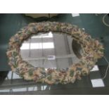 Oval mirror in decorative floral frame