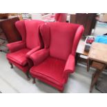 Pair of red fabric wingback armchairs