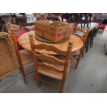 5200 Circular pine dining table plus 4 ladder back chairs with rush seats