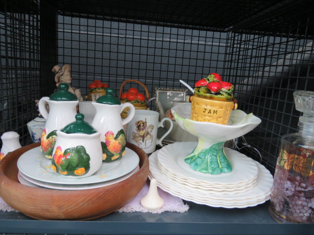 Cage containing Capo Di Monte style figure, jam and marmalade jars, chicken patterned crockery and