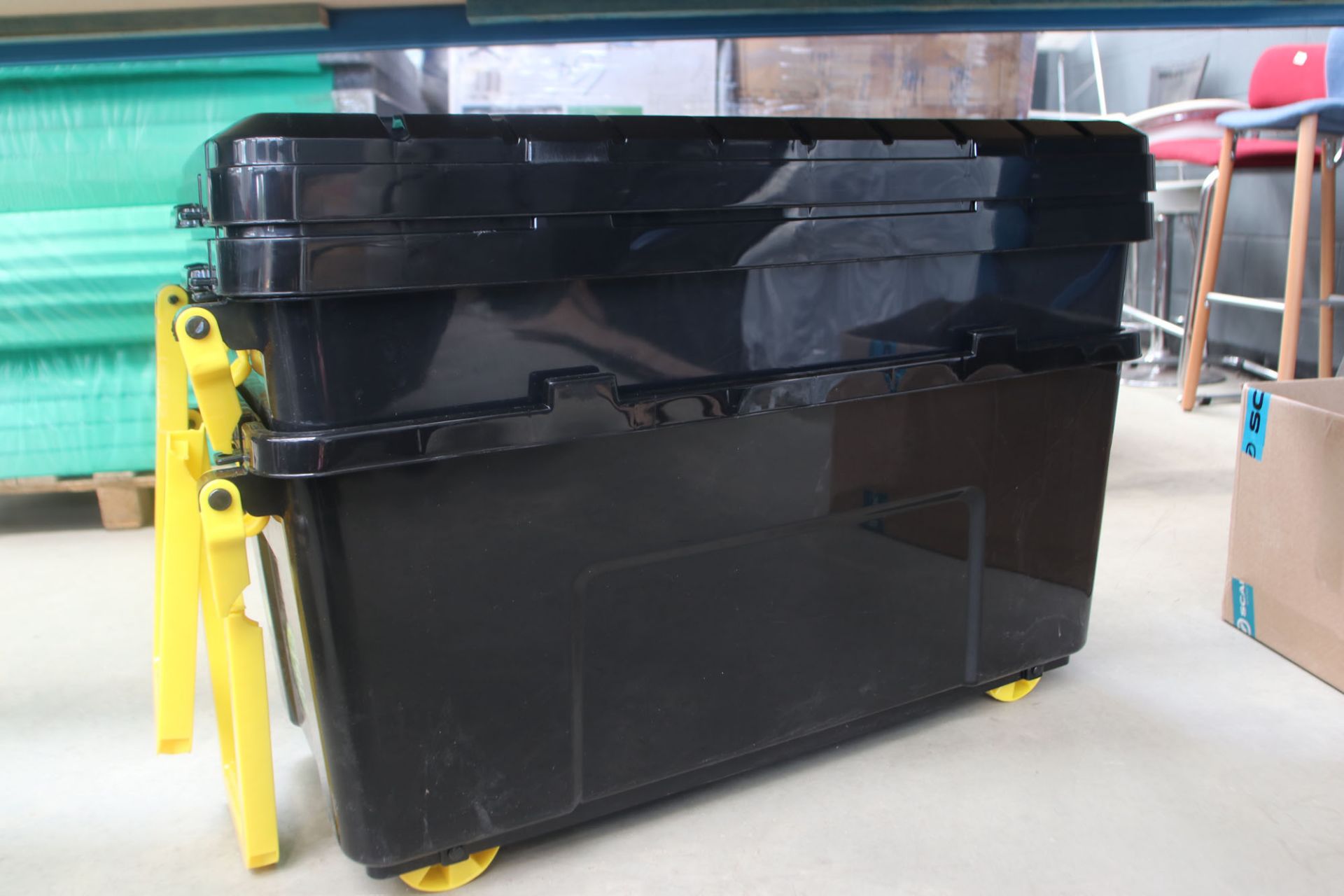 2 black wheeled boxes with lids