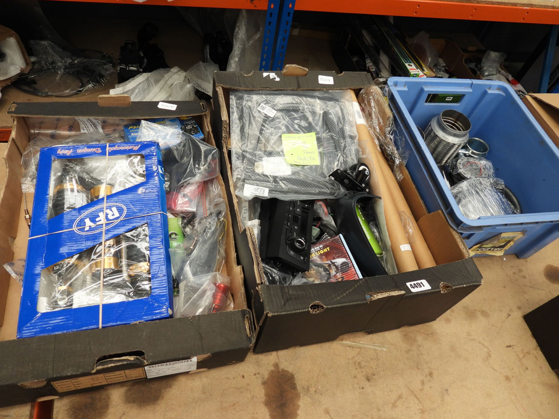 2 cardboard and 1 plastic box containing car parts and accessories