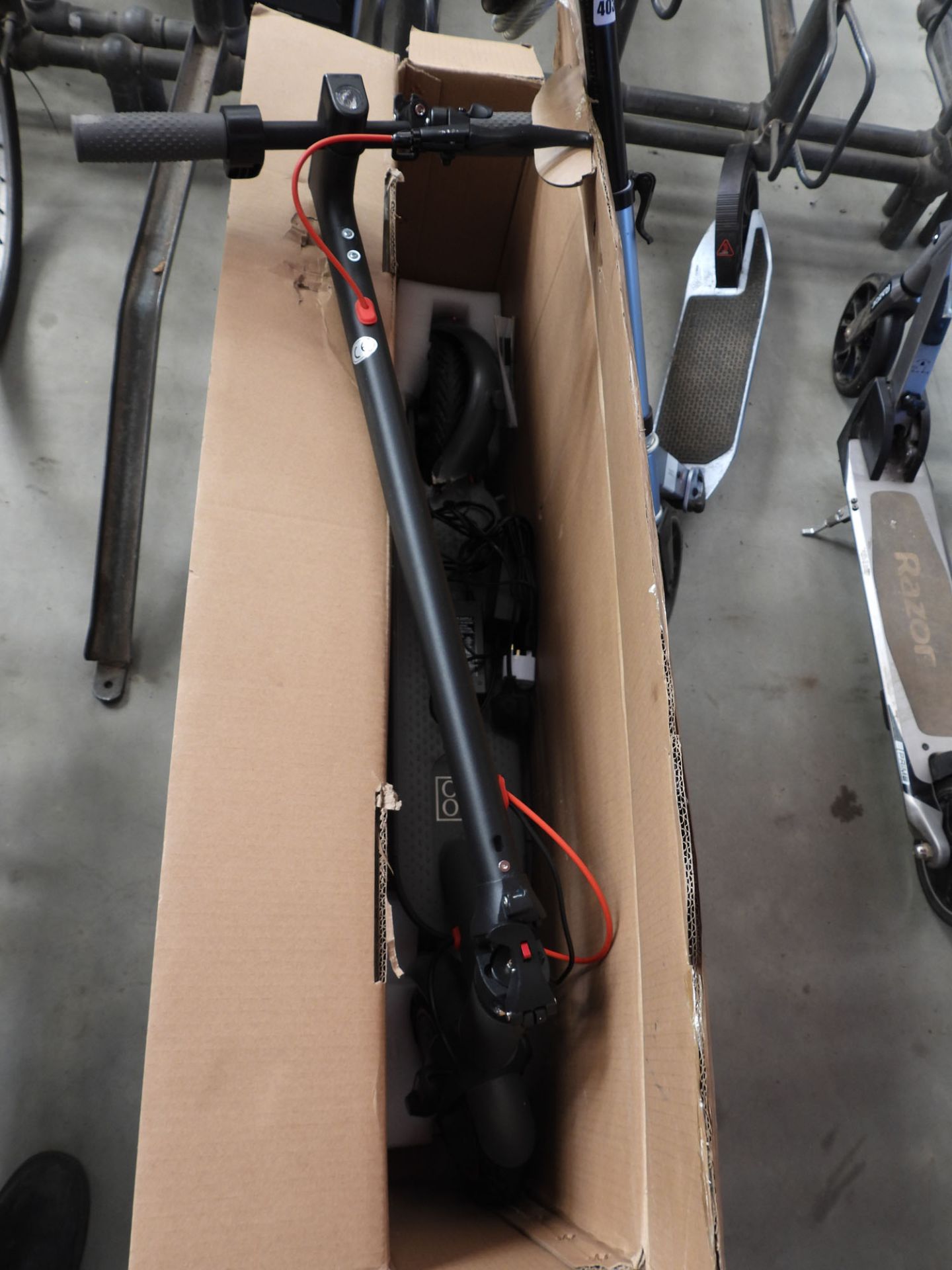 Boxed electric scooter with charger