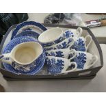 Box containing blue and white teacups and saucers plus a milk jug