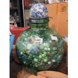 Carboy with a large quantity of marbles