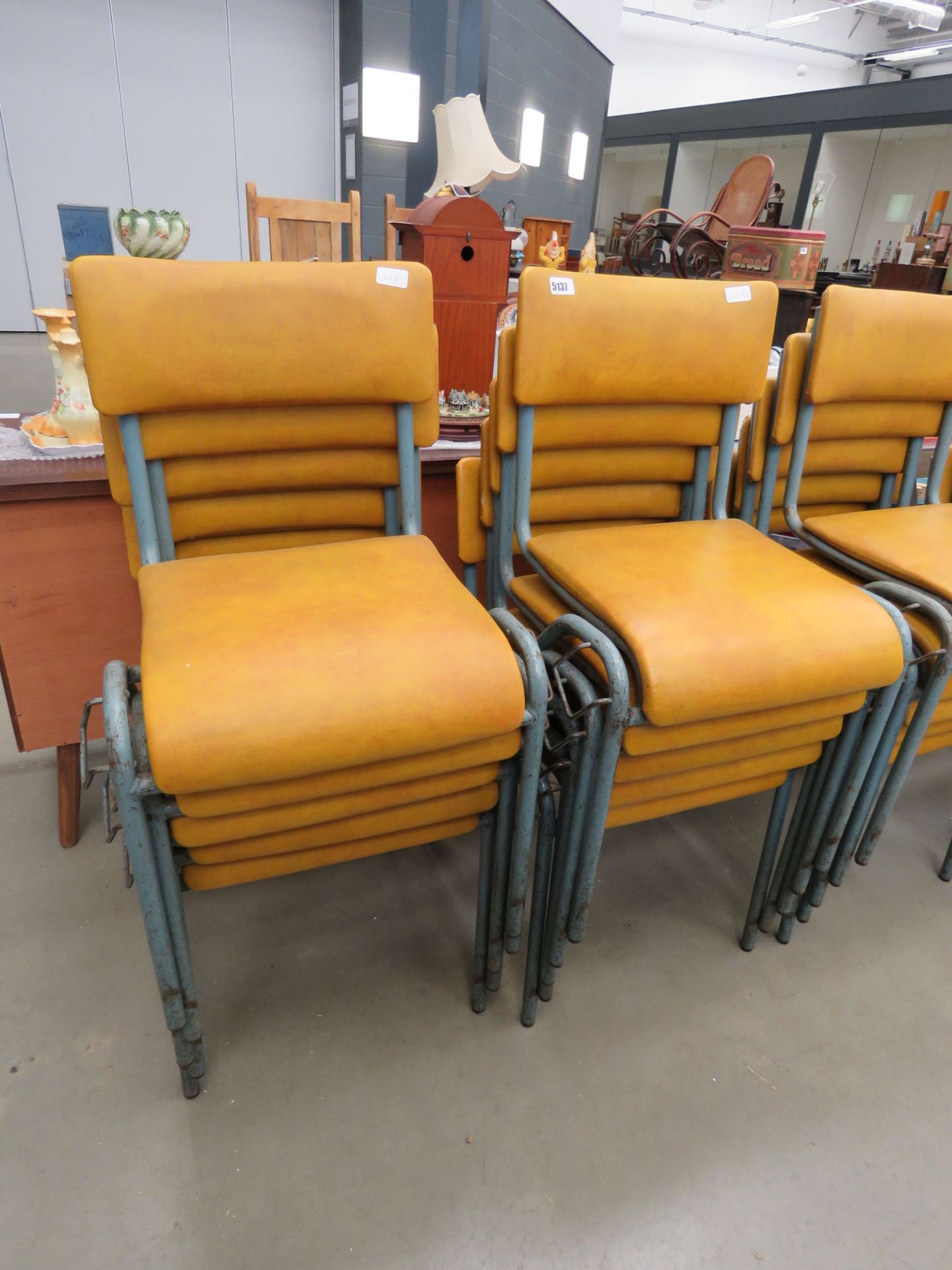 10 mustard leather effect and metal stacking chairs