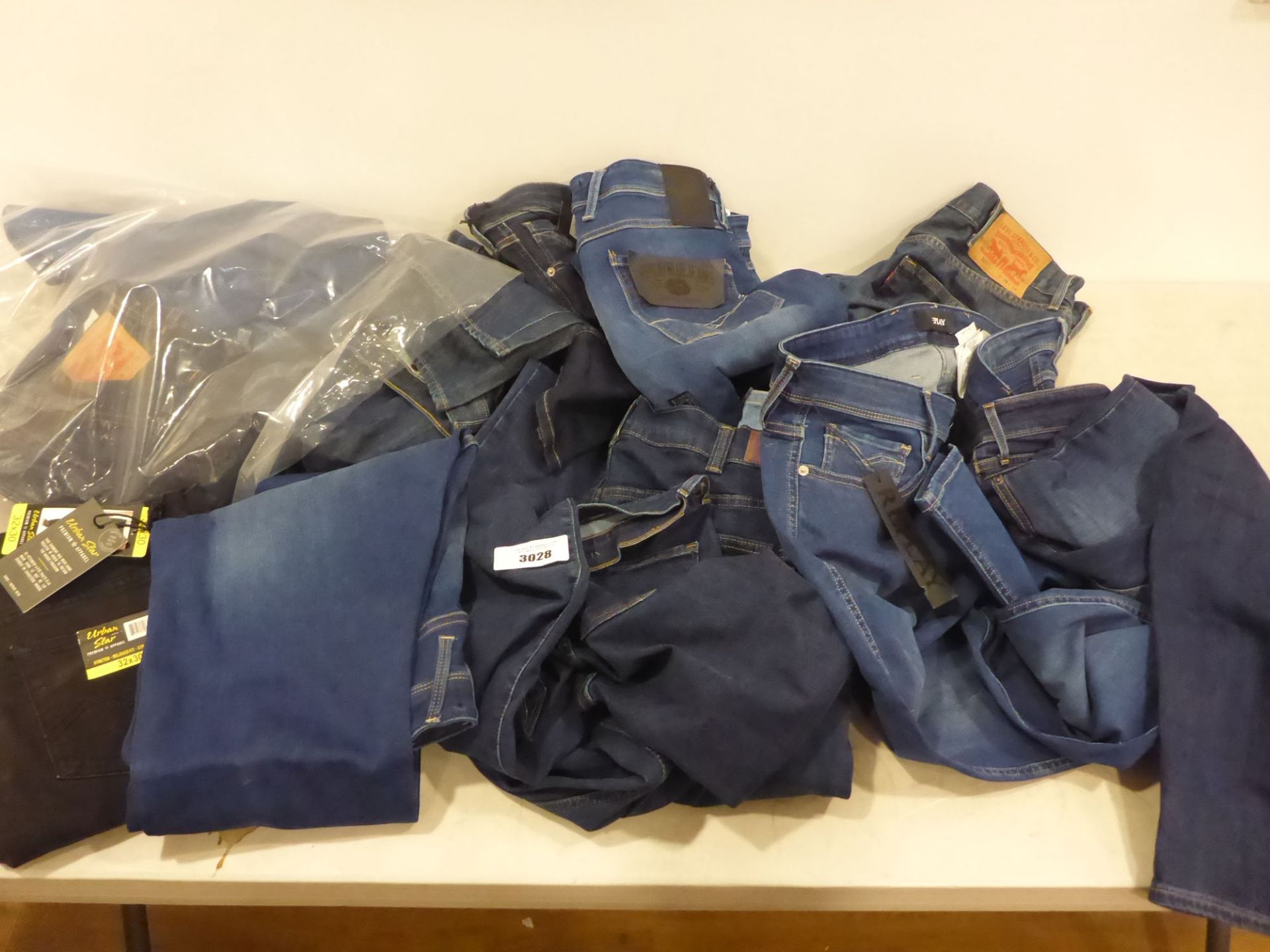 Bag containing various makes of ladies and men's jeans