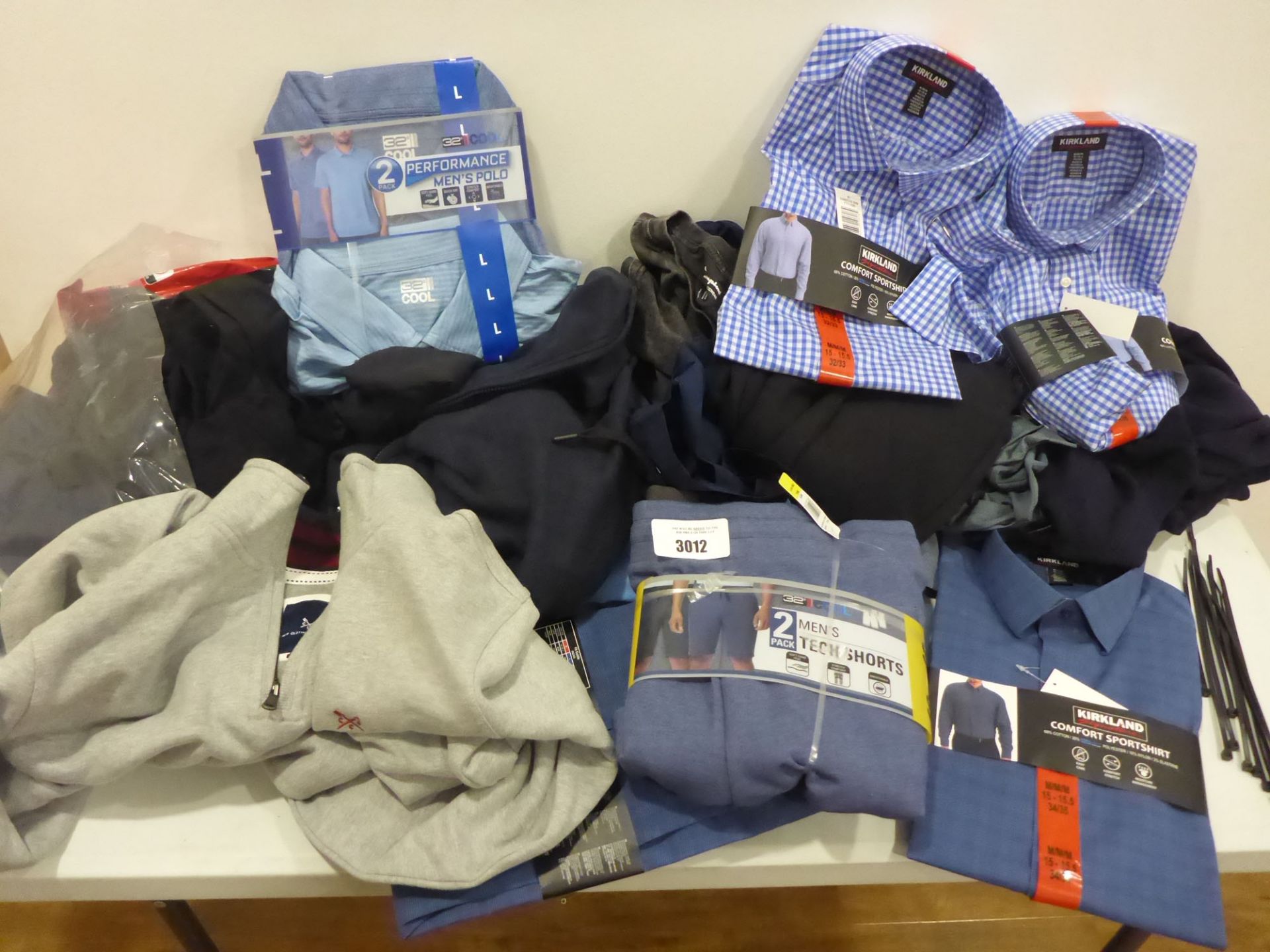 Bag containing men's shirts, fleece tops, hot weather tops etc