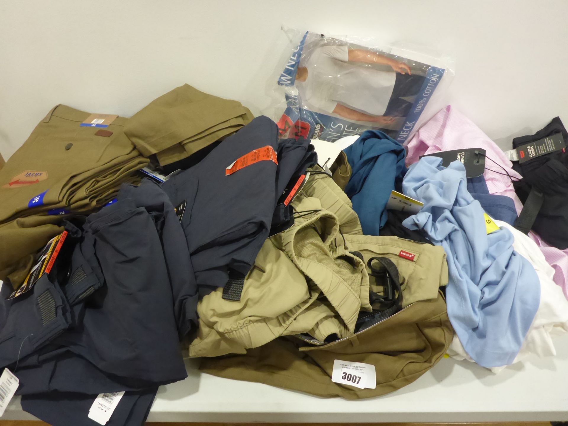 Bag containing men's clothing, including trousers, shorts, shirts etc