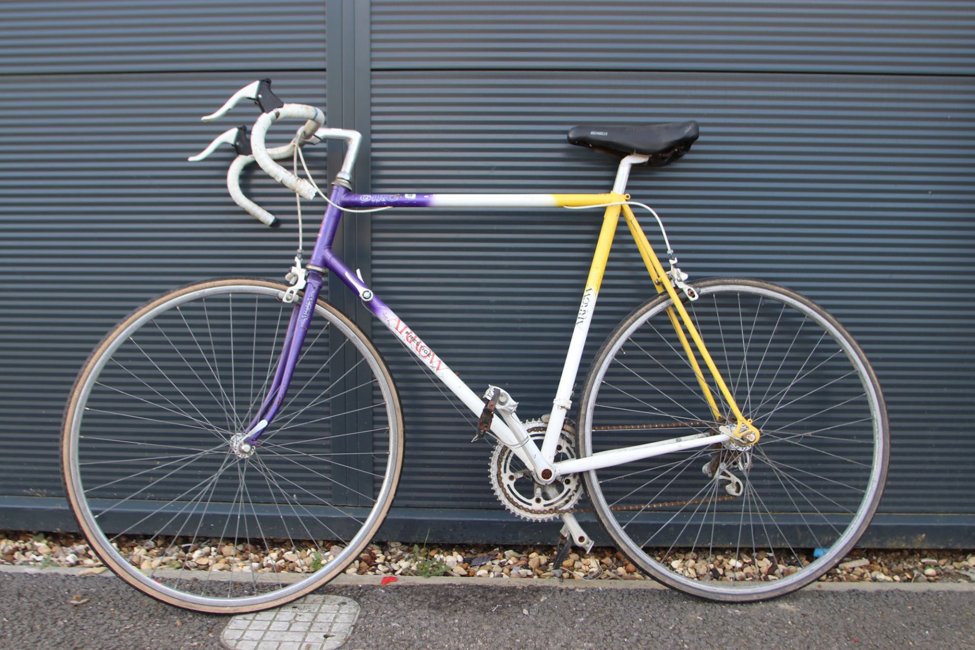 Purple, white and yellow racing cycle