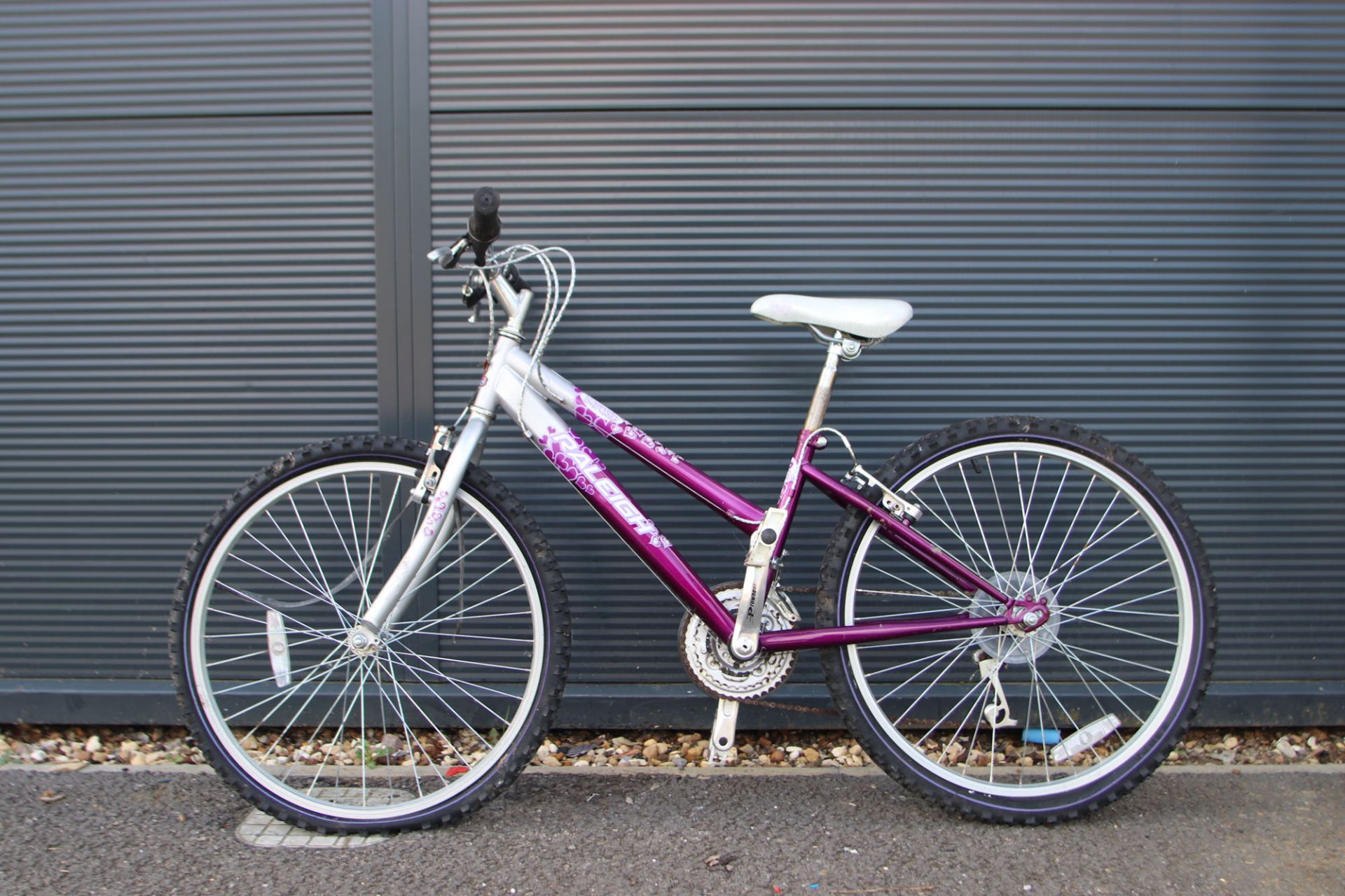 Pink and silver Raleigh girls bike