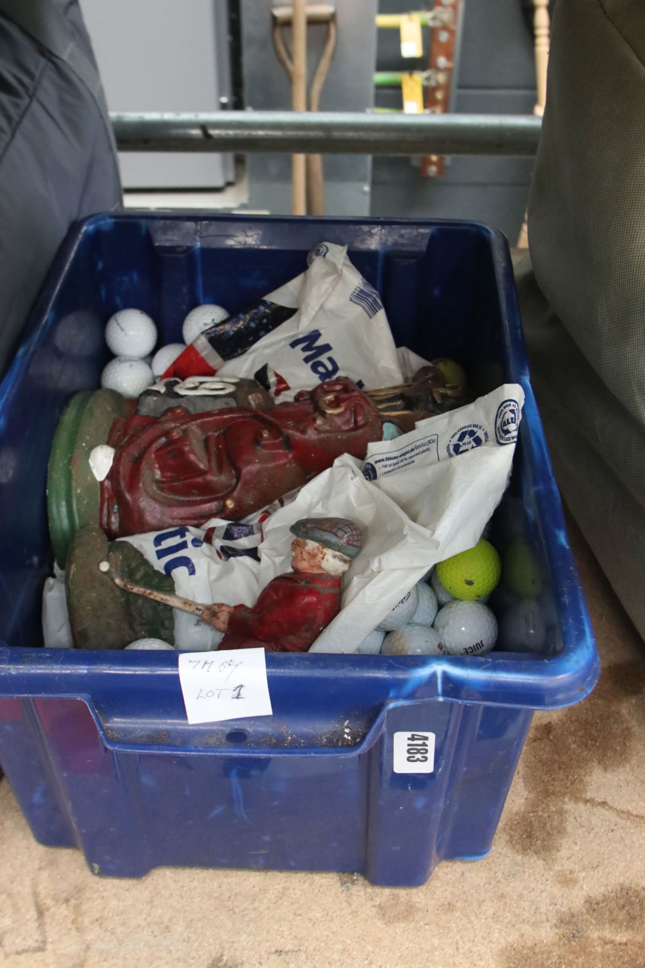 Box containing golf balls and golf doorstops