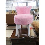 Single pink fur topped bedroom table on white supports