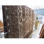 Large carpet in brown and white with floral and geometric pattern