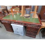 Twin-pedestal kneehole desk with green leather top insert