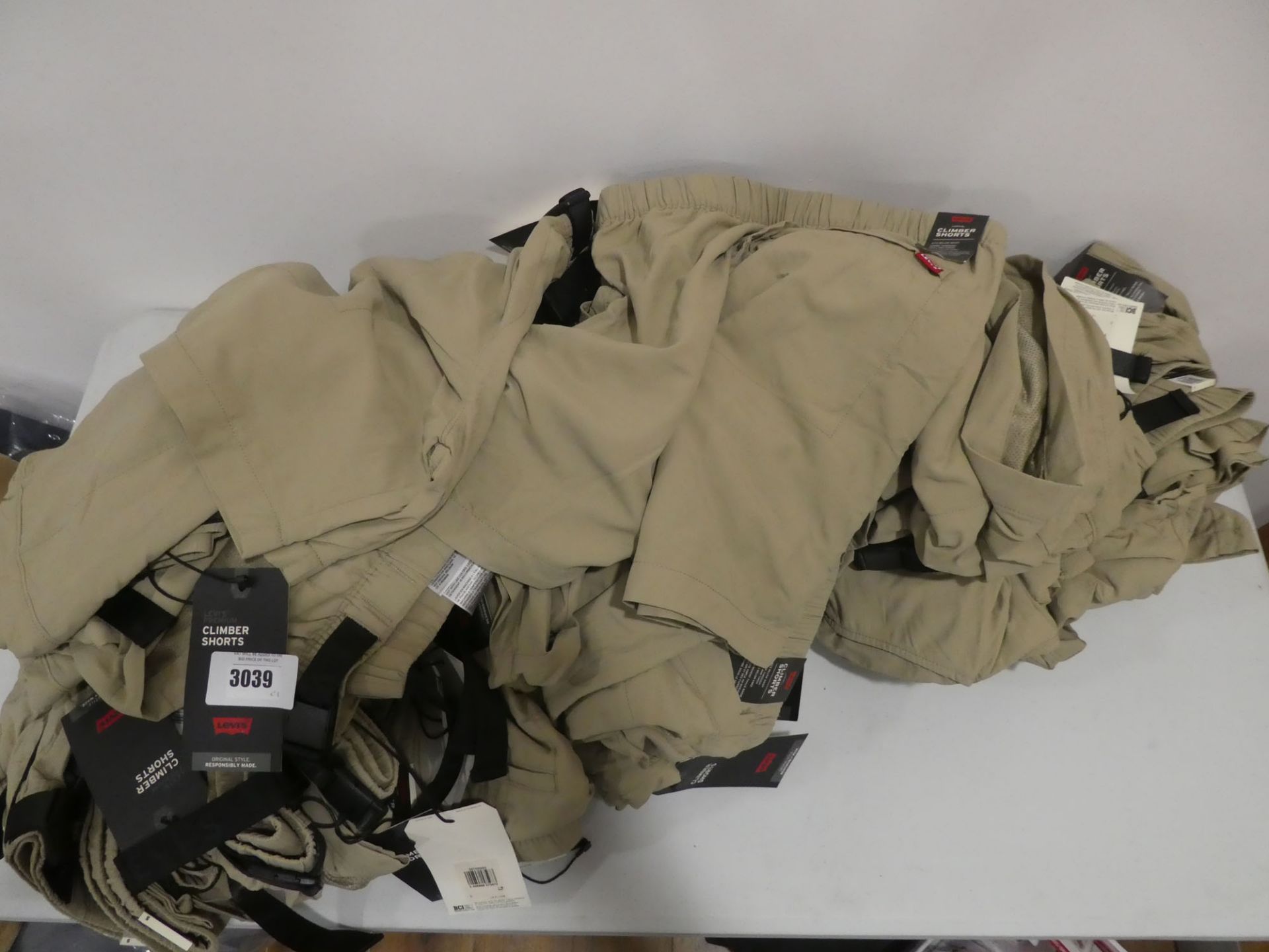 Bag containing khaki Levi's premium climber shorts, all tagged