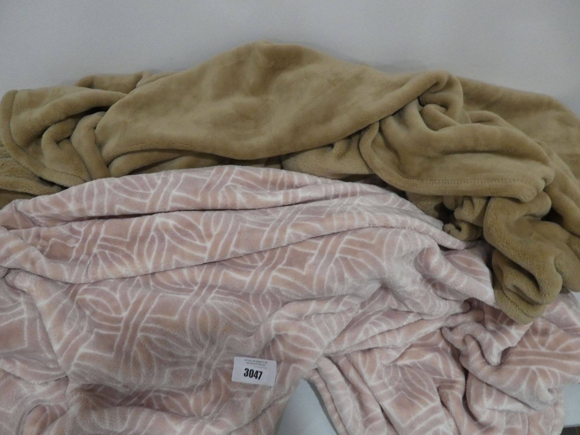 Pair of throws in brown and patterned pink