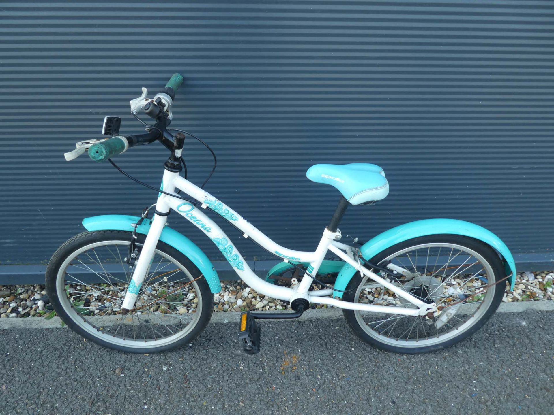 White and turquoise child's cycle