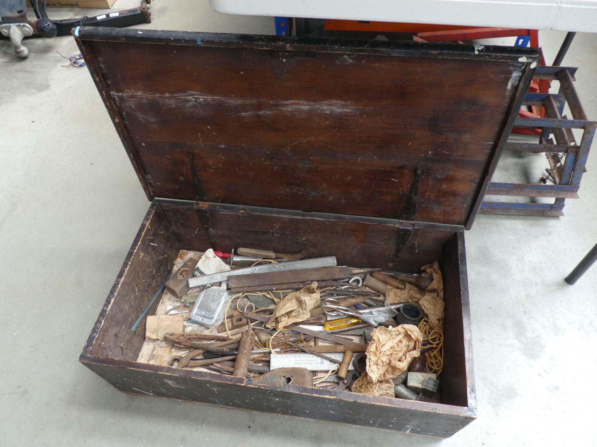 Wooden toolbox with an assortment of tools