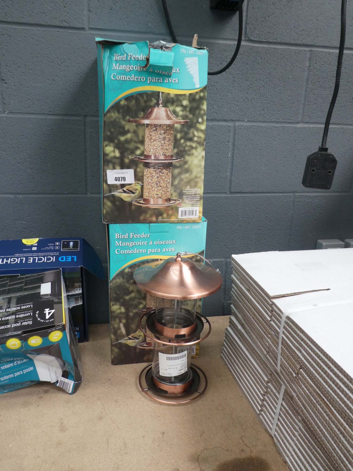 2 boed and 1 unboxed bird feeders and 2 boxes of lights