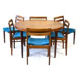 A 1960's Scandinavian rosewood circular extending dining table with a chamfered frieze and tapering