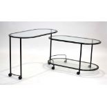 An Italian serving table, the black enamelled frame inset with oval glass tiers,
