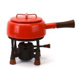 A French fondue set including ared enamelled and teak mounted pan and matching burner,