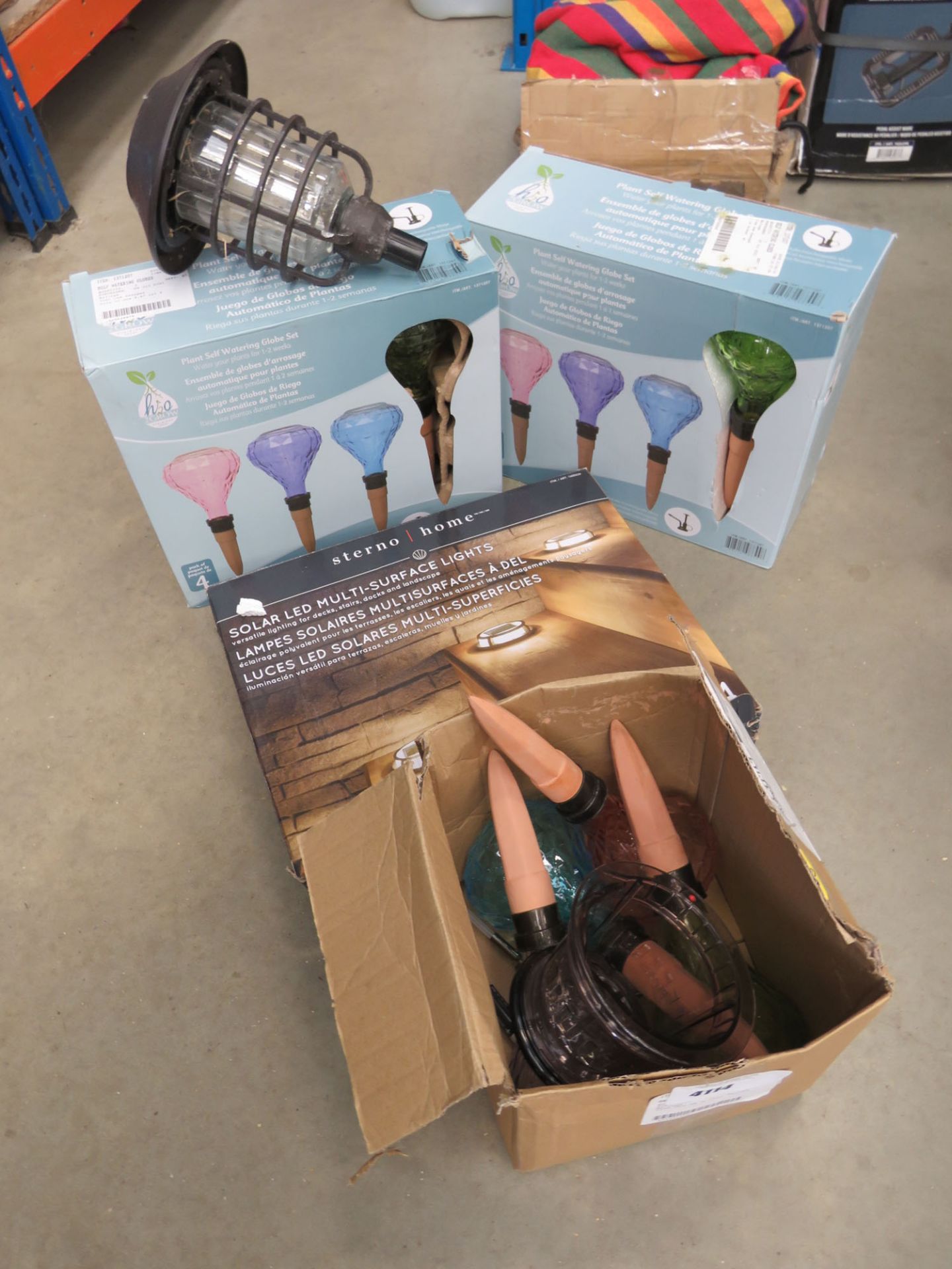 3 boxes of self watering globes and a set of solar led surface lights