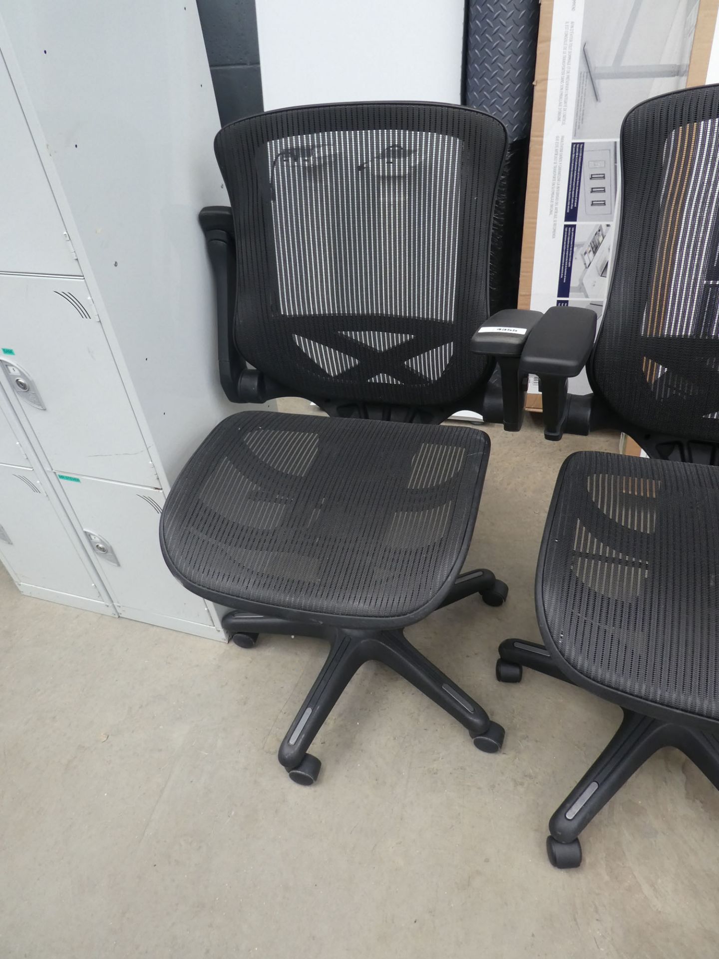 Black mesh office swivel armchair on black base