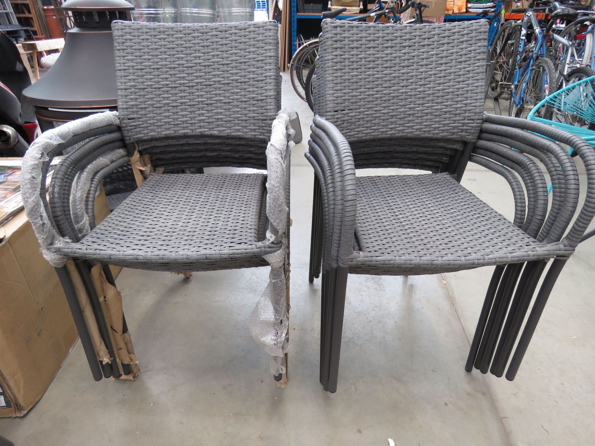 2 grey rattan stacking garden chairs on grey support