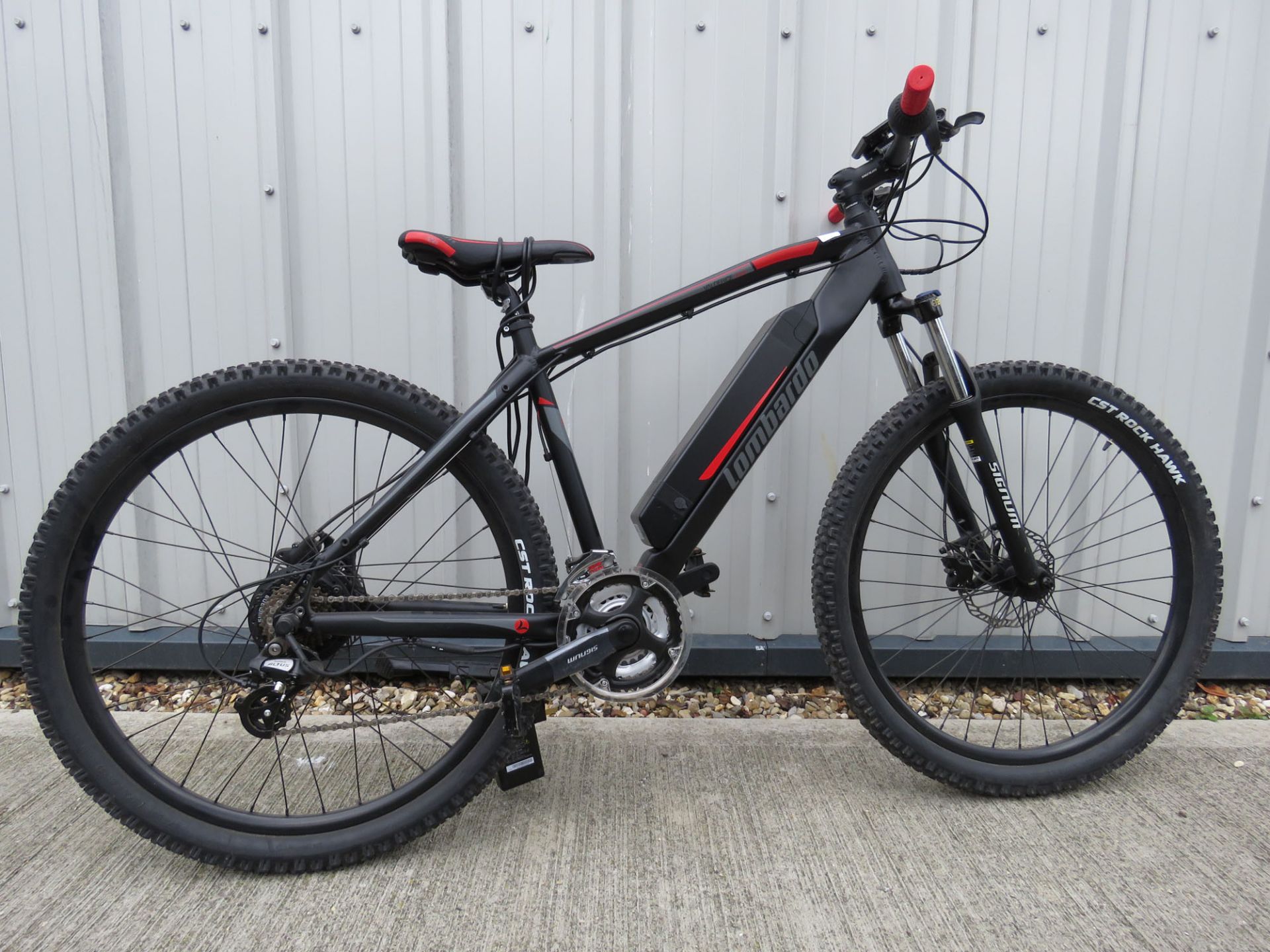 CST Rock Hawk electric mountain bike in black and red with charger