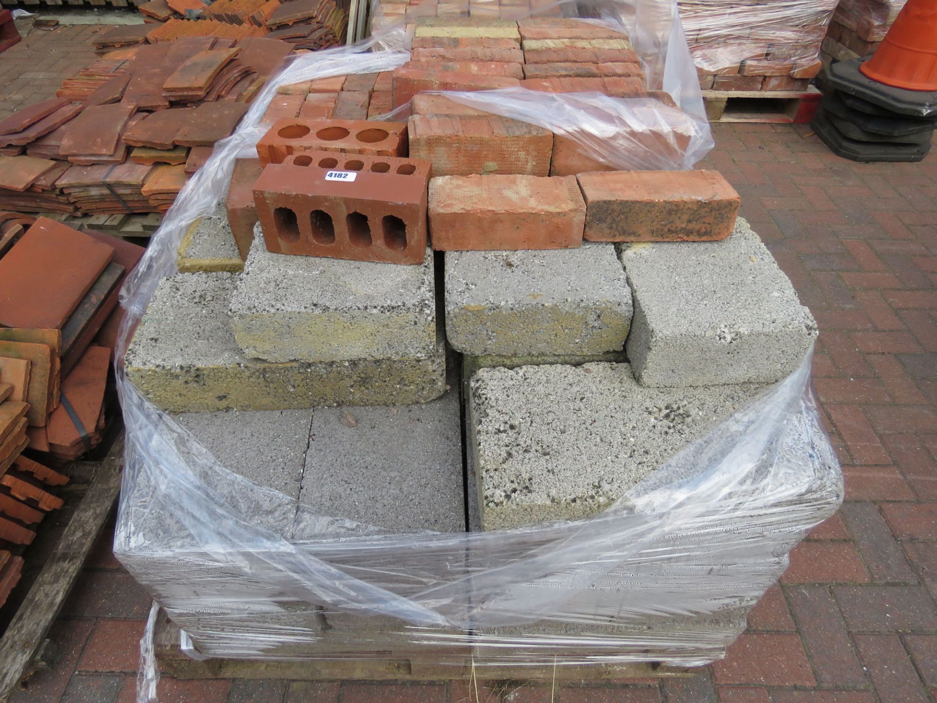 4 pallets to include roof tiles, blocks and red bricks