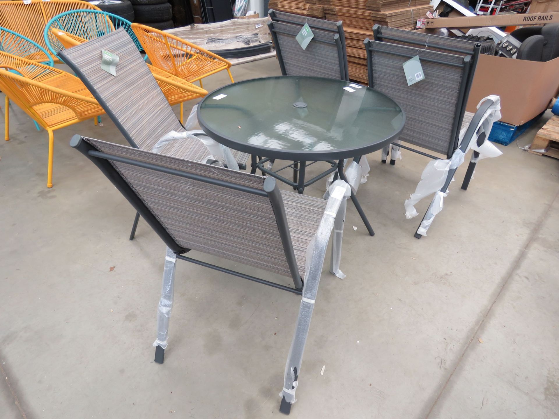 Circular glass top garden table with 6 matching chairs