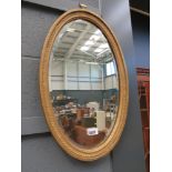 Oval bevelled mirror in gilt frame