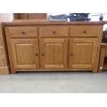 Oak sideboard of three drawers, three doors under