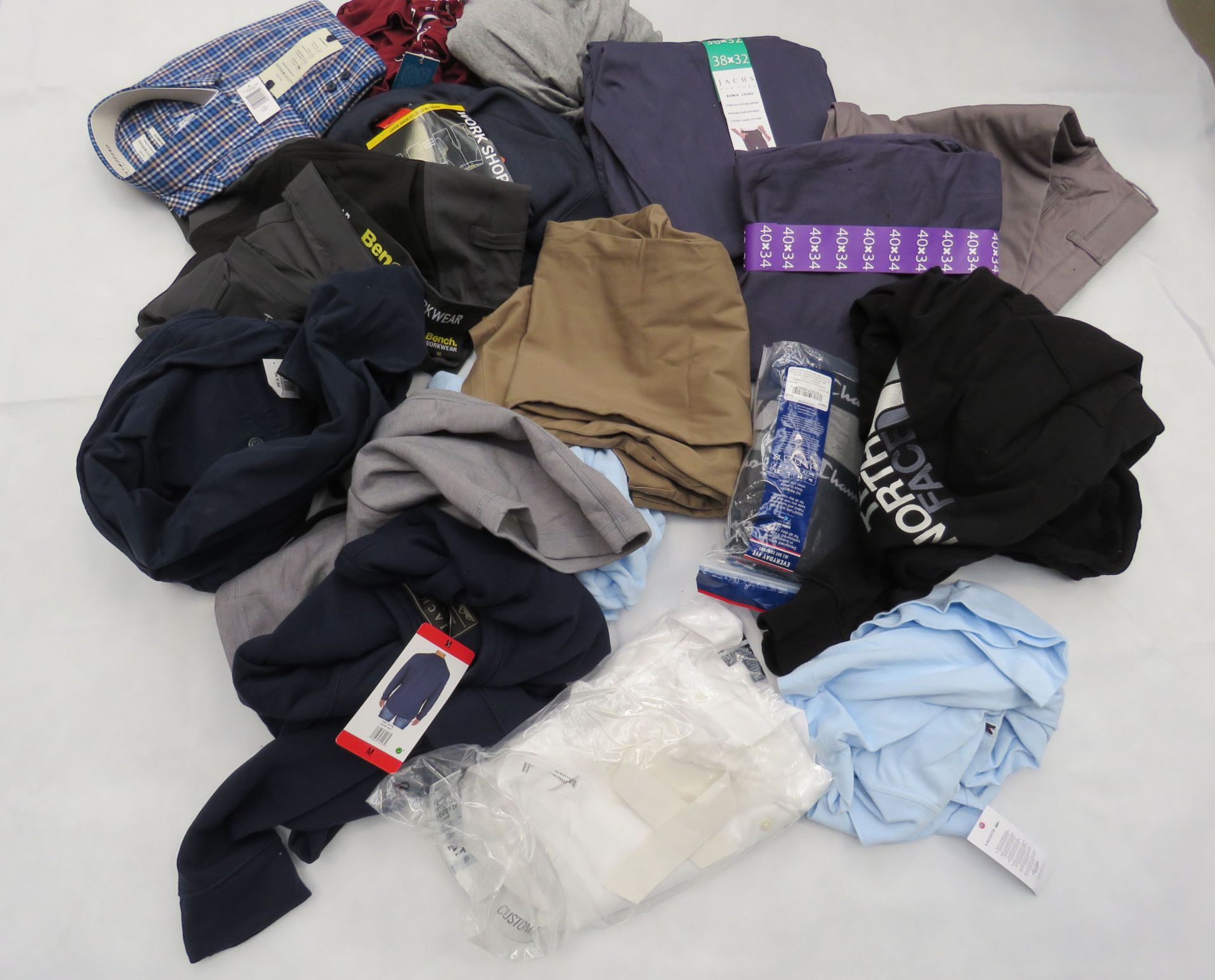 Large bag containing mixed clothing incl. shirts, polo shirts, trousers, etc.