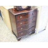 Serpentine fronted mahogany effect four drawer chest