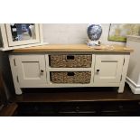 (8) Modern oak 2 door entertainment unit with 2 seagrass storage baskets under