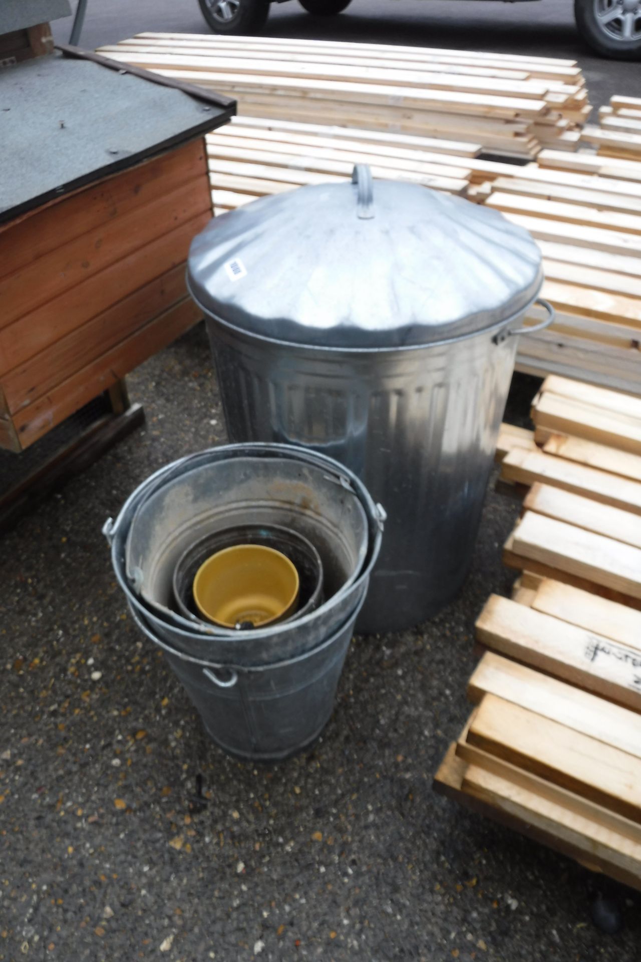 Metal garden bin with assorted metal buckets