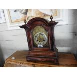 Mahogany veneer mantle clock with brass face, pendulum and key