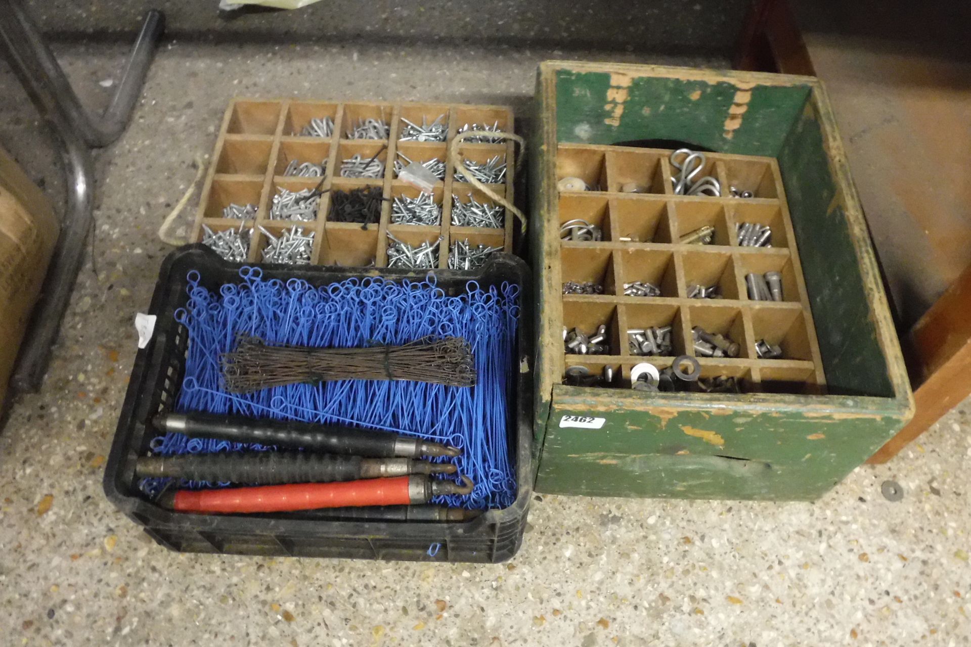 2 boxes of various screws and bolts with black crate of various building ties