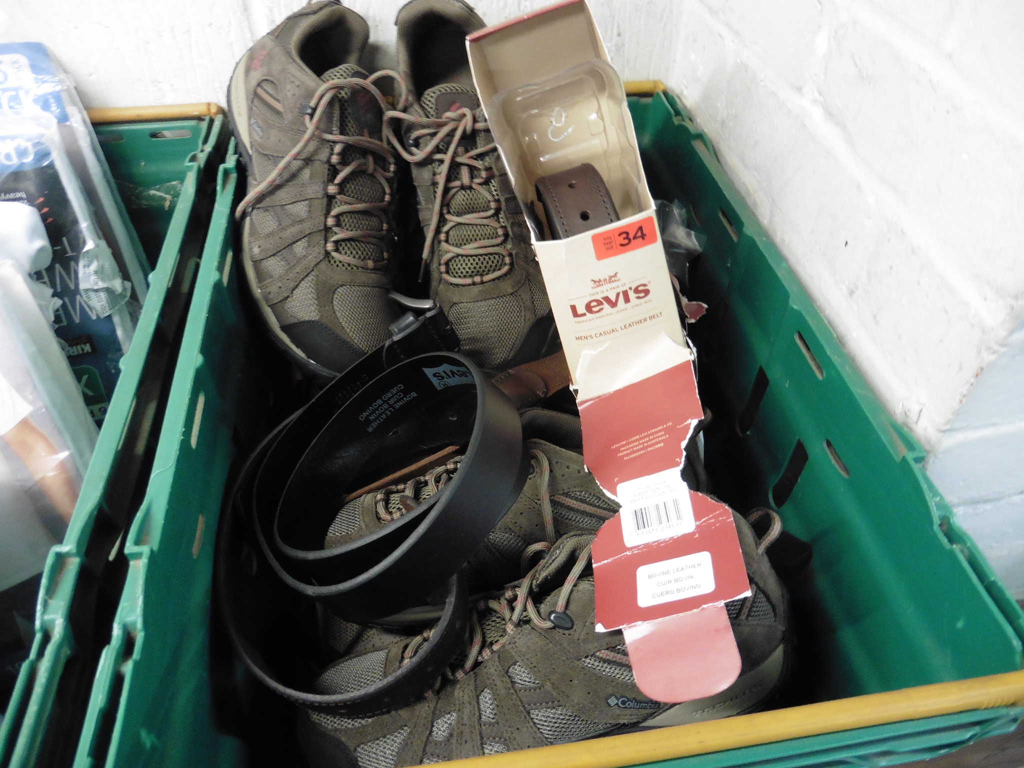 Crate of various Levi belts and trainers