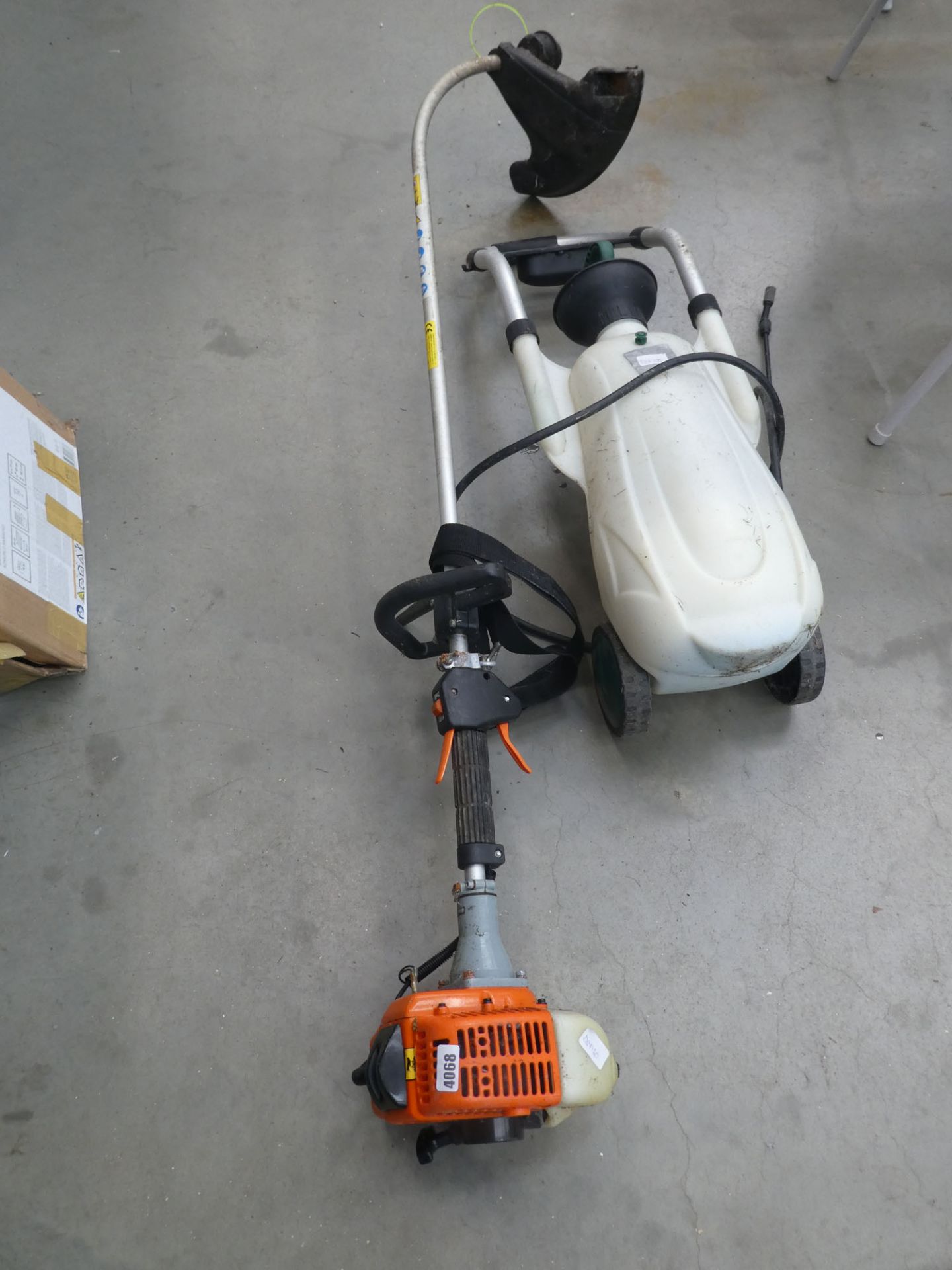 Petrol powered strimmer and a small wheel along sprayer