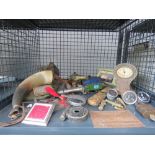 Cage containing powder horn, Massey Ferguson and Bike Norton signs, clock, ornamental cars, and