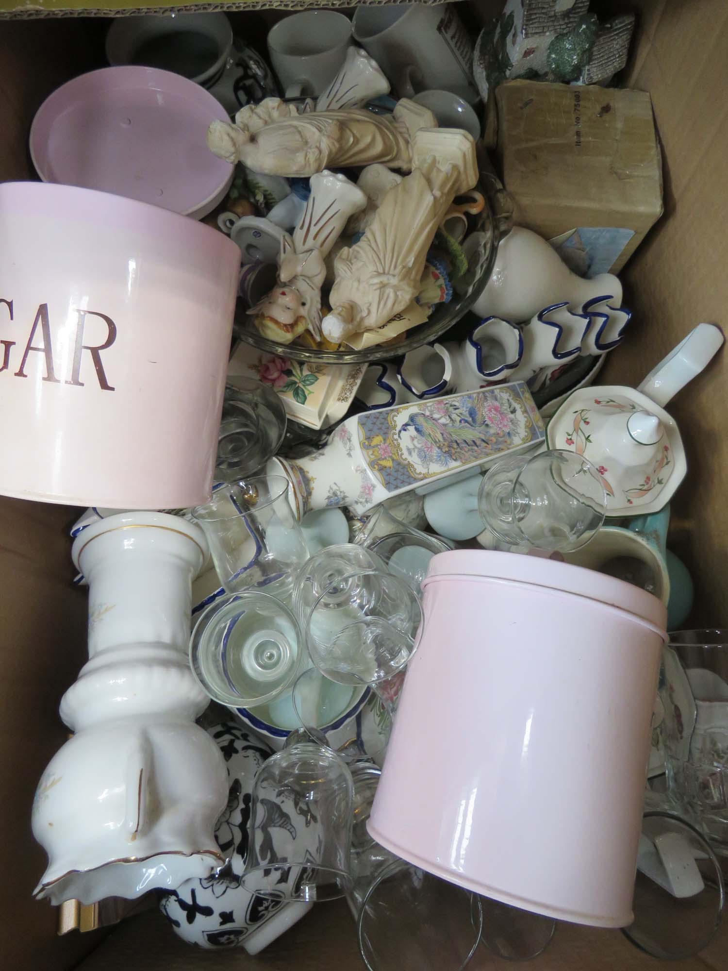 Box containing wine glasses and tumblers, ornamental religious figures, metal kitchen storage