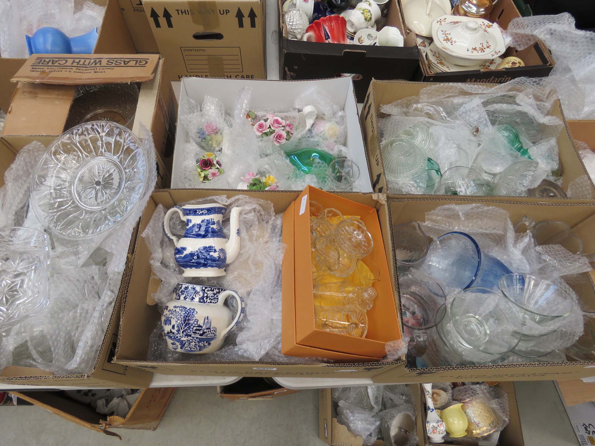 6 boxes containing glassware, blue and white crockery and ornamental posies