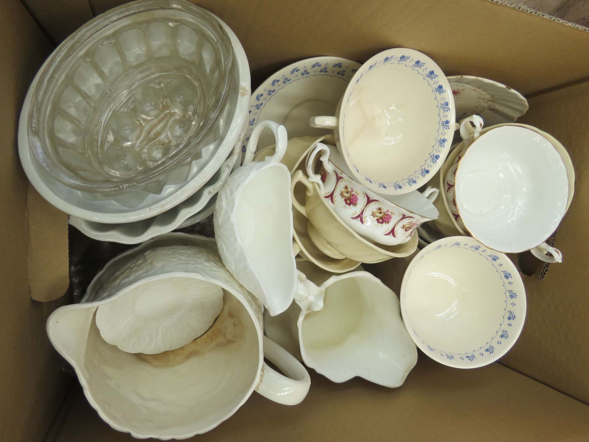 Box containing a quantity of Masons and other crockery plus jelly molds and jugs