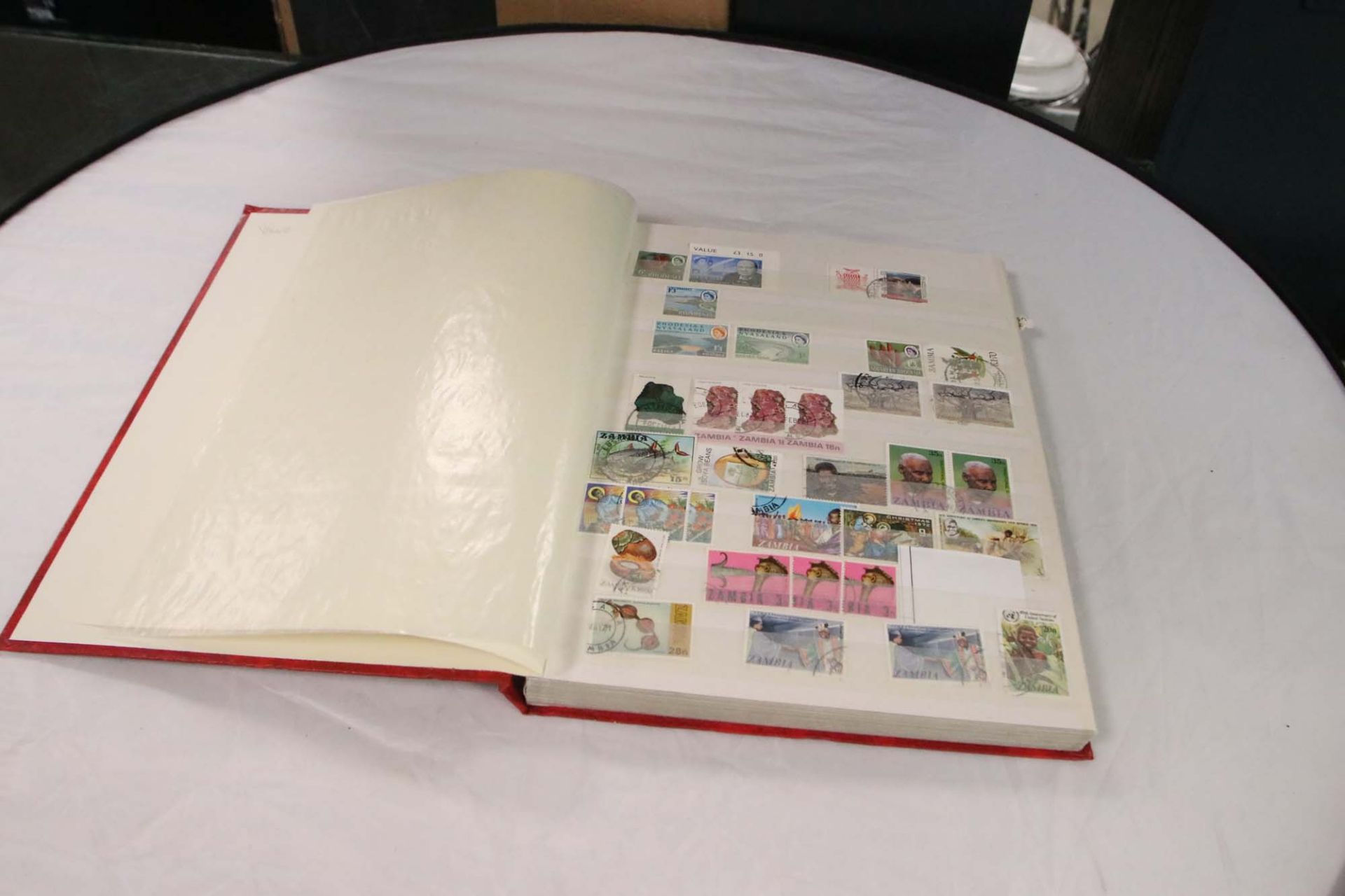 Red folder containing a collection of Queen Victoria and Edwardian stamps